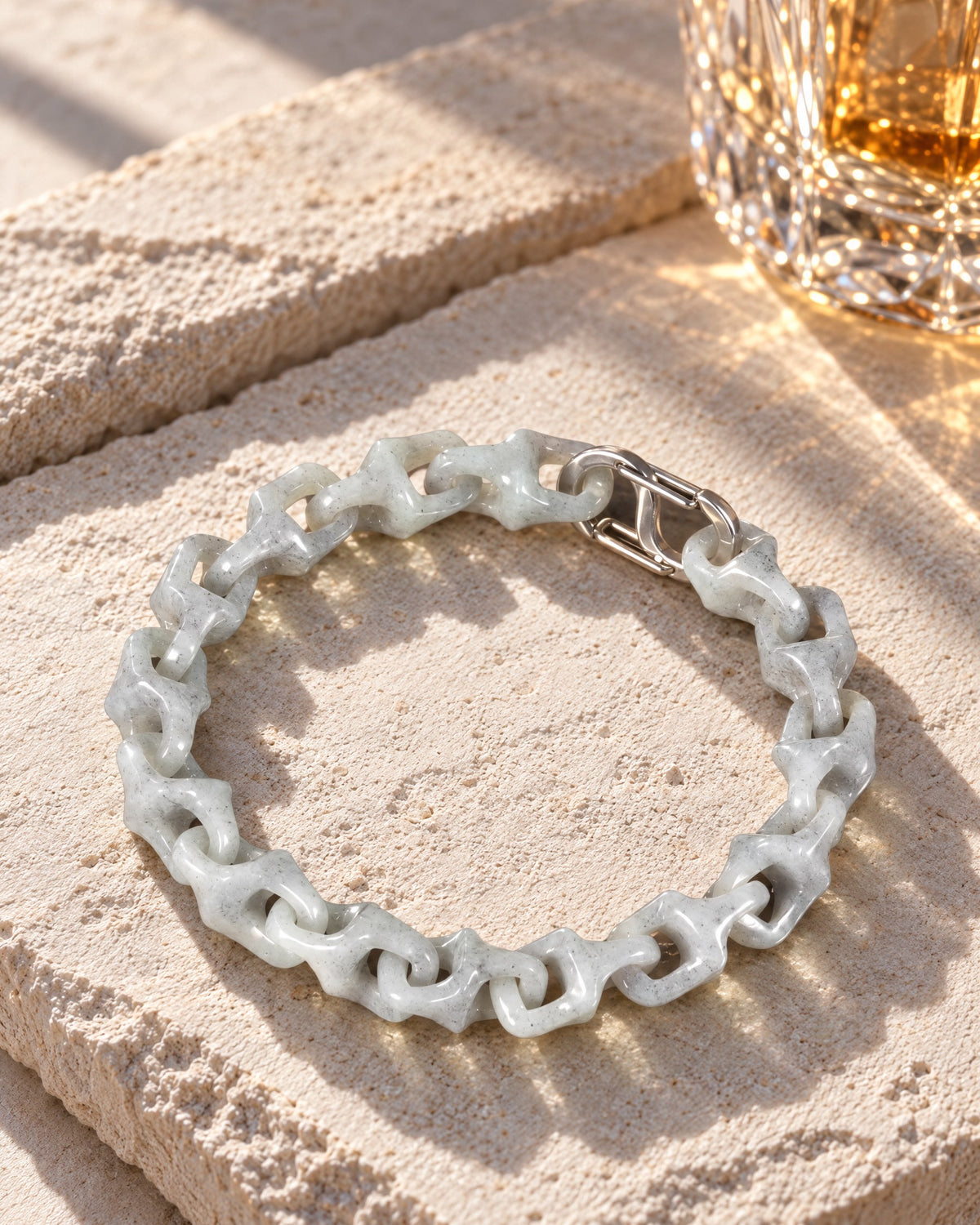 Dragon Spine Bracelet In Grey Jade on pale limestone in warm sunlight