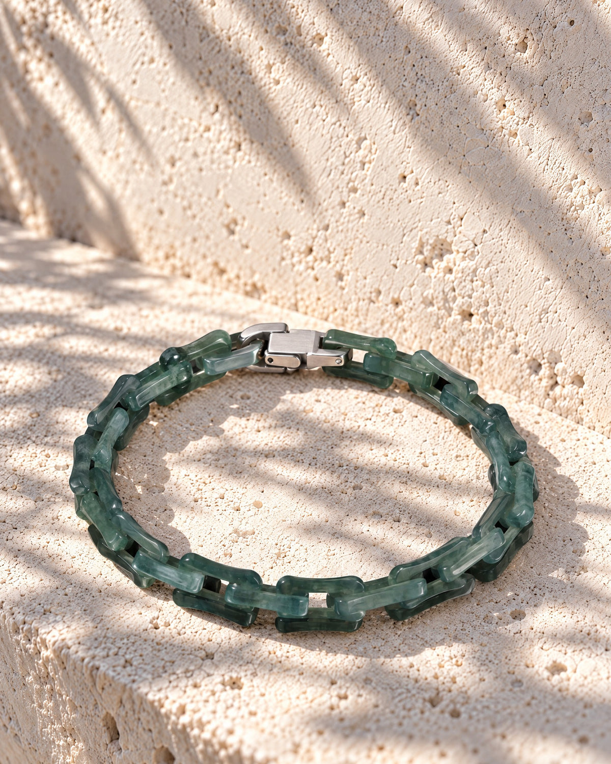 Square Cable Chain Bracelet In Green Mayan Jade on pale limestone in warm sunlight