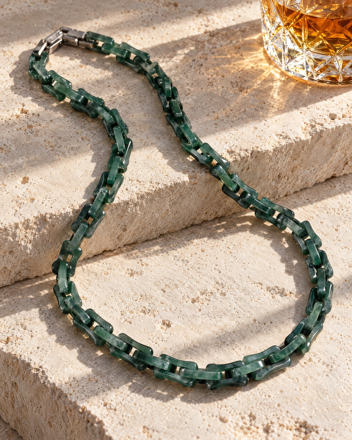 Square cable green Mayan jade necklace on limestone steps