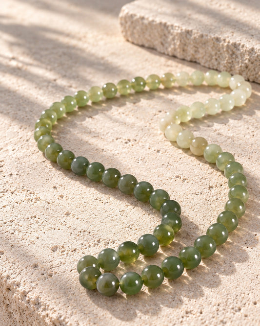 Ombre Round Bead Necklace In Nephrite on white stone: Pale limestone tabletop