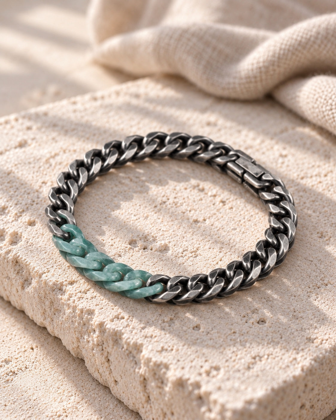 Classic Cuban Chain Bracelet In Green Jade With Oxidized Stainless Steel on white stone: Angled limestone slab