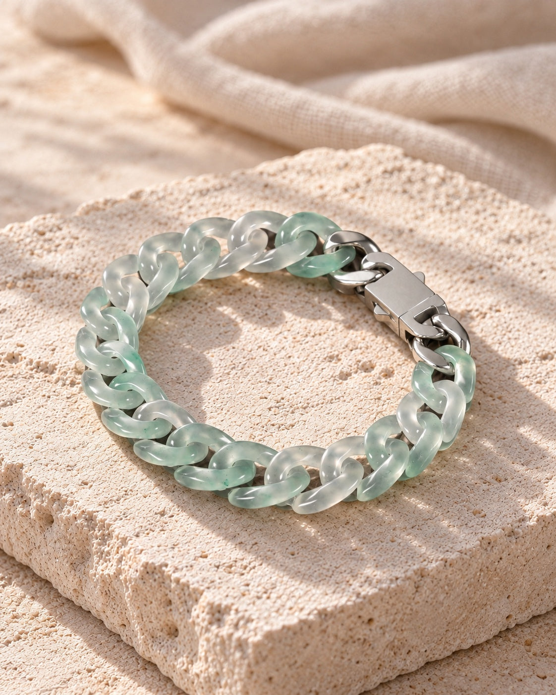 Classic Cuban Link Chain Bracelet In Light Green African Jade on white stone: Angled limestone slab