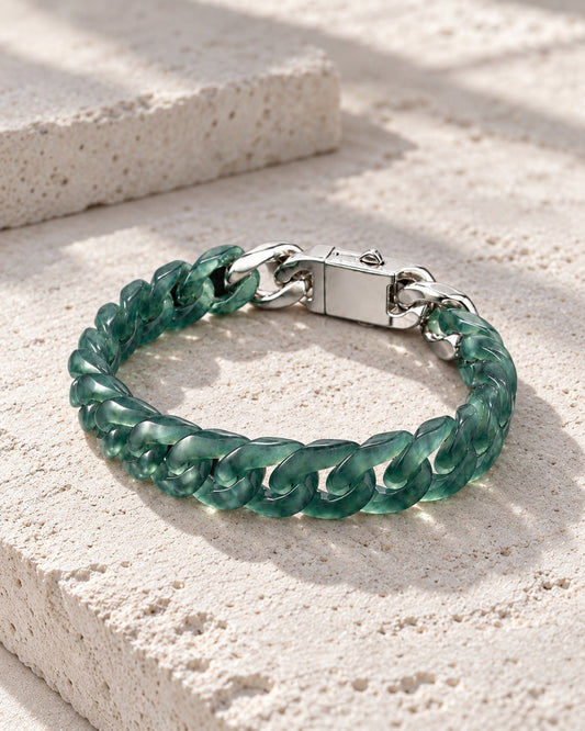 Classic Cuban Link Chain Bracelet In Top Icy Dark Green Guatemalan Jade on white stone: Pale limestone tabletop