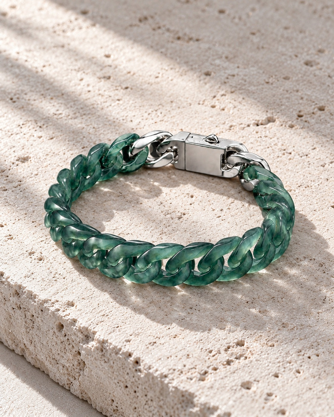 Classic Cuban Link Chain Bracelet In Top Icy Dark Green Guatemalan Jade on white stone: Quiet stone flat lay