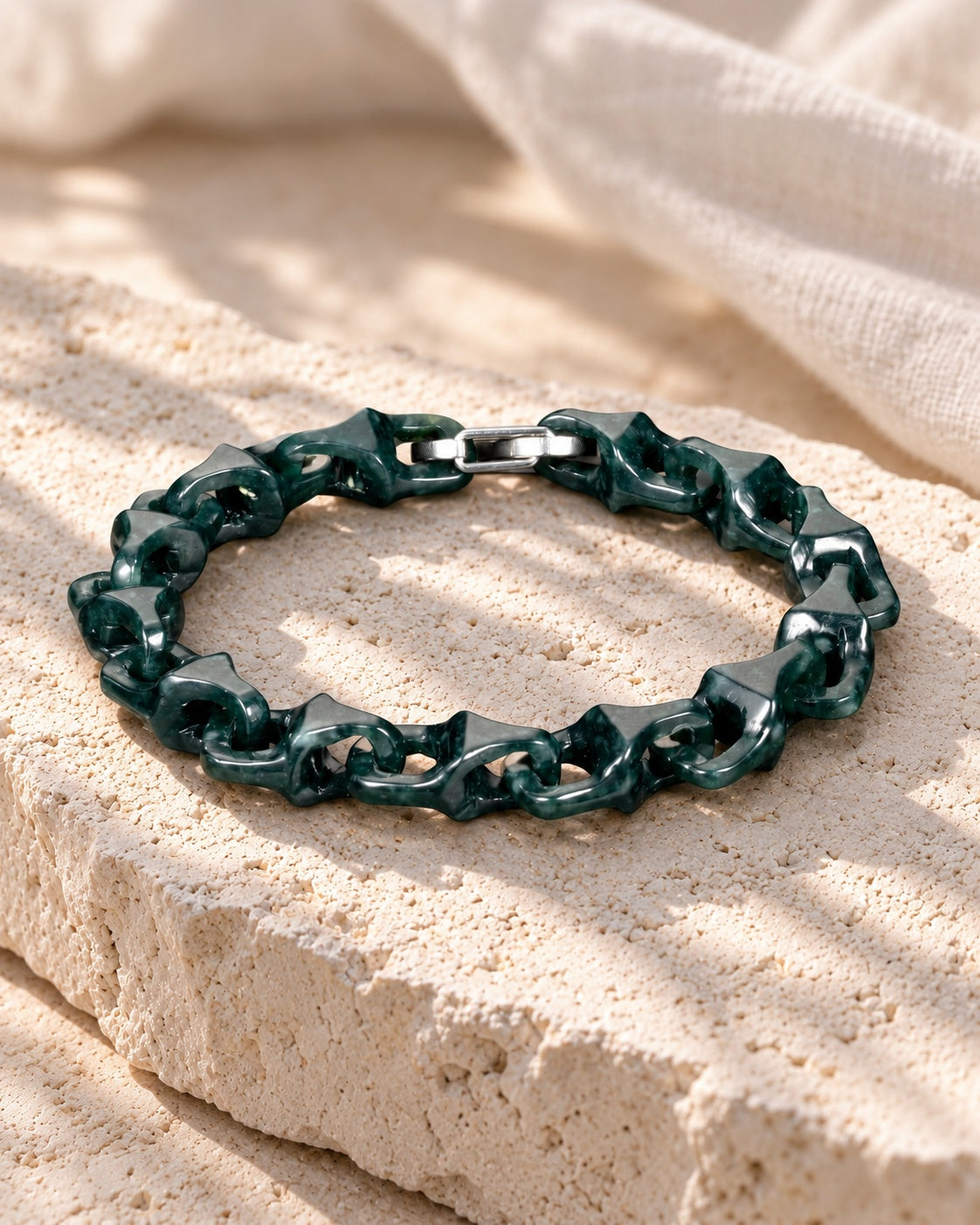 Dragon Spine Bracelet In Dark Green Mayan Jade on white stone: Angled limestone slab