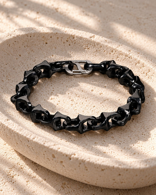 Dragon Spine Bracelet In Black Mayan Jade on white stone: Shallow stone dish