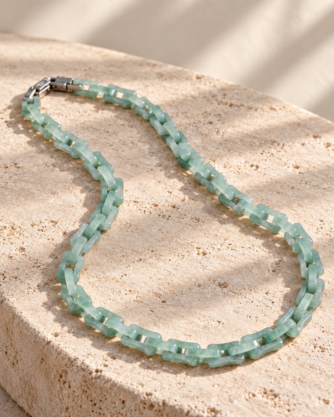 Square Cable Chain Necklace In Light Green Mayan Jade on white stone: Rounded travertine ledge