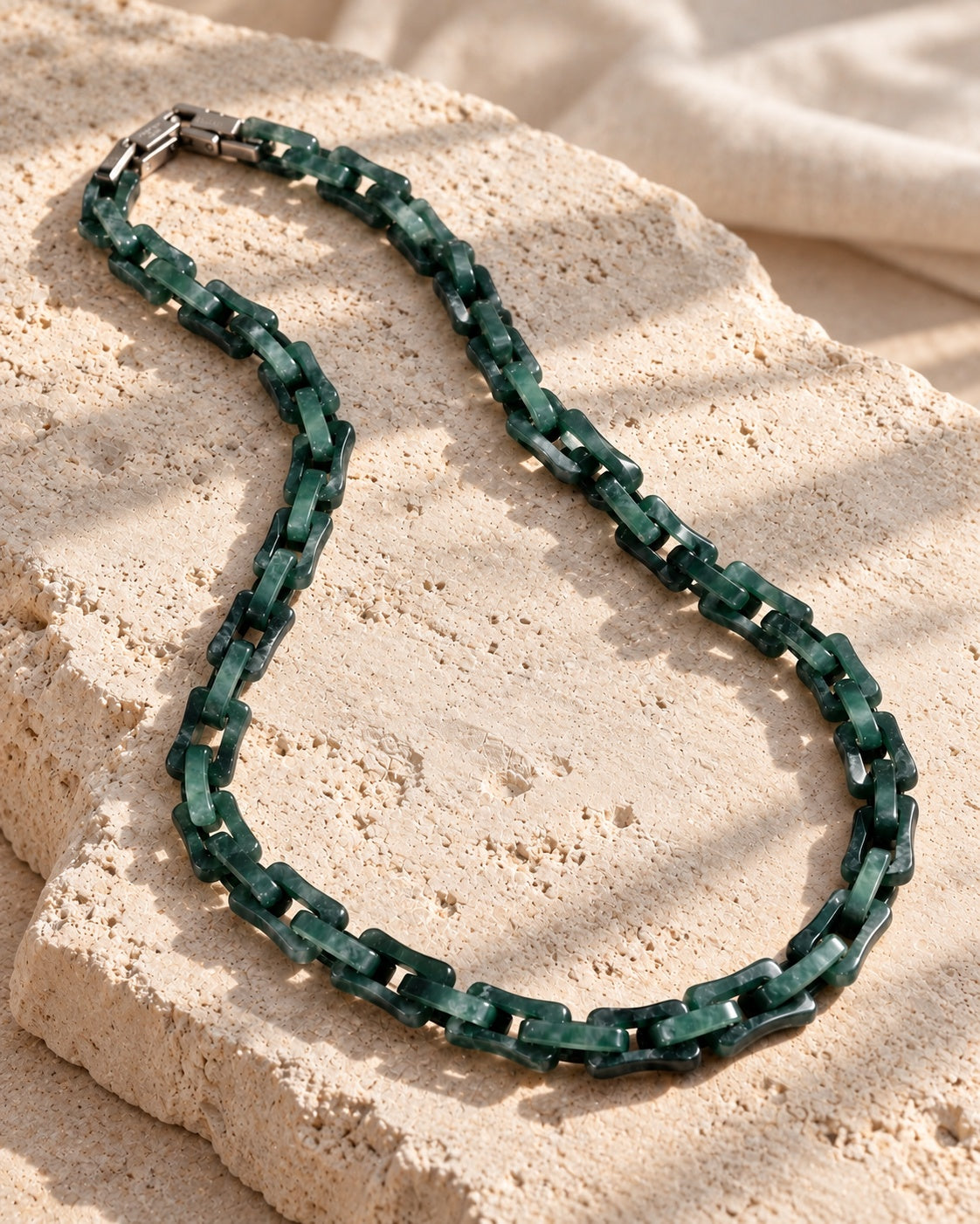 Square Cable Chain Necklace In Dark Green Mayan Jade on white stone: Angled limestone slab